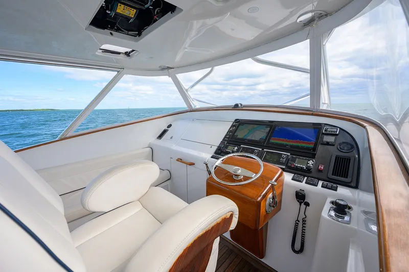 Slide: The Image of Helm of 2014 Release Boatworks 46 with modern navigation equipment and ocean view. - 38