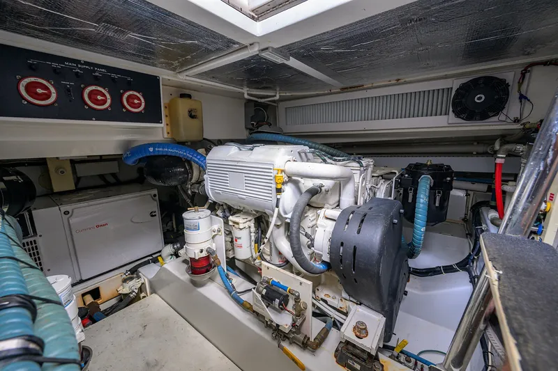 Slide: The Image of Engine room of 2014 Release Boatworks 46, featuring Cummins Onan generator and main supply panel. - 56