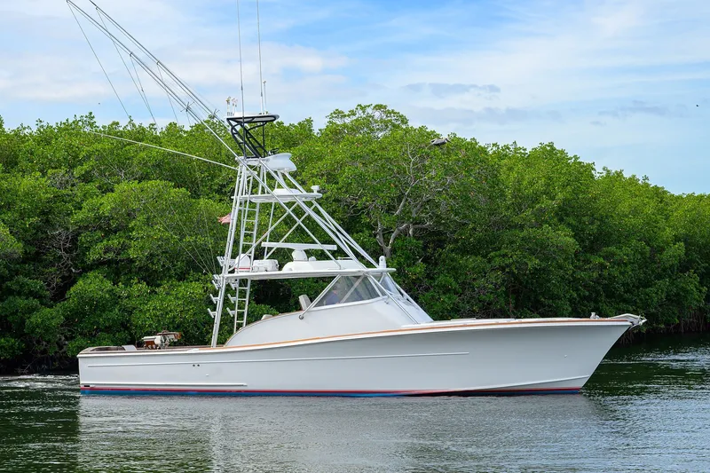 Slide: The Image of 2014 Release Boatworks 46 yacht cruising near lush green mangroves. - 6