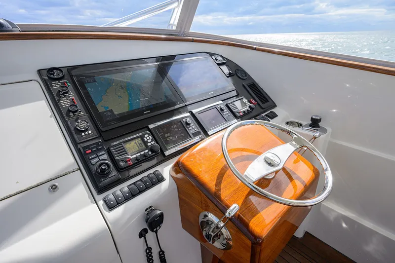 Slide: The Image of Helm of 2014 Release Boatworks 46 with navigation equipment and wooden steering wheel. - 35