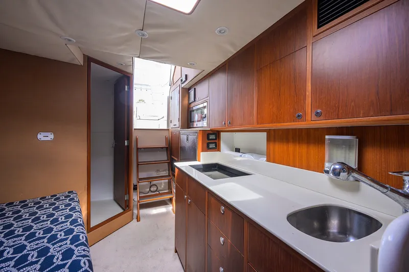 Slide: The Image of Luxurious interior of 2014 Release Boatworks 46, featuring a modern kitchenette and cozy seating. - 46