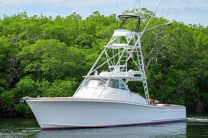 Slide: The Image of 2014 Release Boatworks 46 yacht cruising near lush green mangroves. - 9