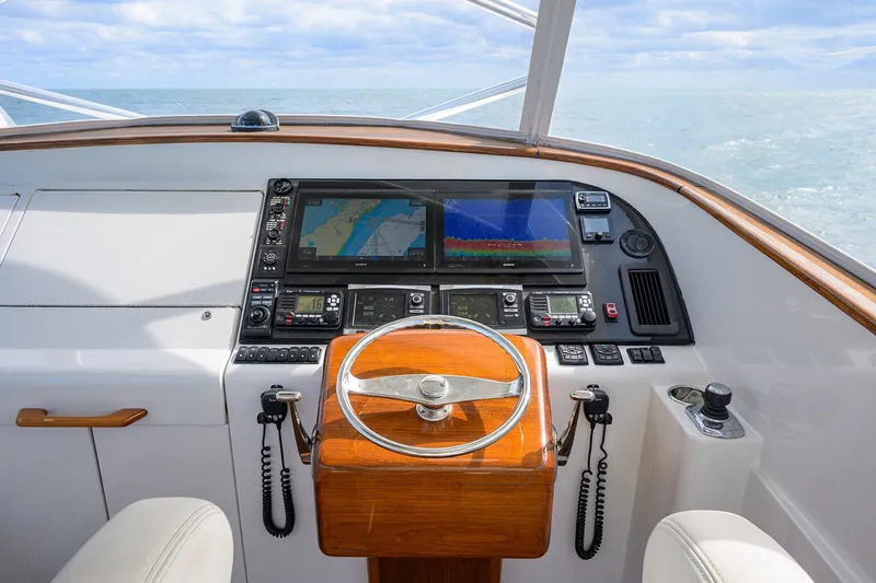 Slide: The Image of Helm of 2014 Release Boatworks 46 with navigation screens and wooden steering wheel. - 37