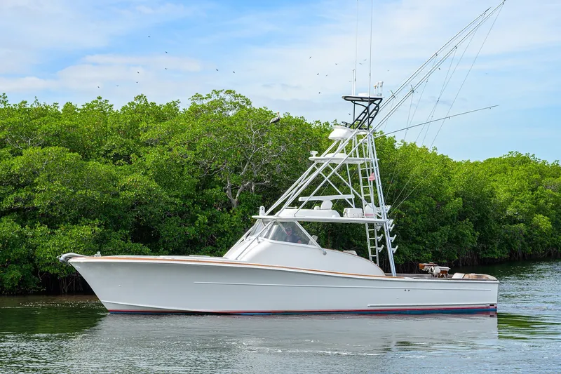 The Image of 2014 Release Boatworks 46 yacht cruising near lush green mangroves. - 0