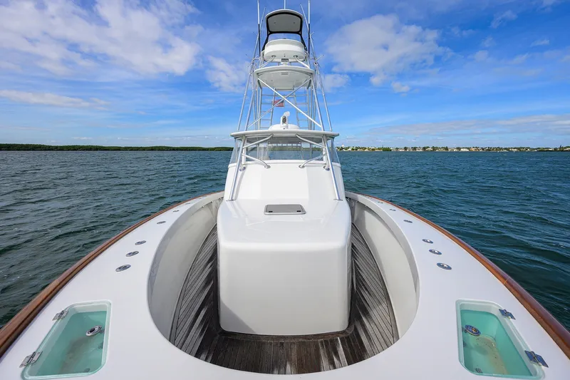 Slide: The Image of 2014 Release Boatworks 46 on open water, showcasing sleek design and spacious deck. - 14