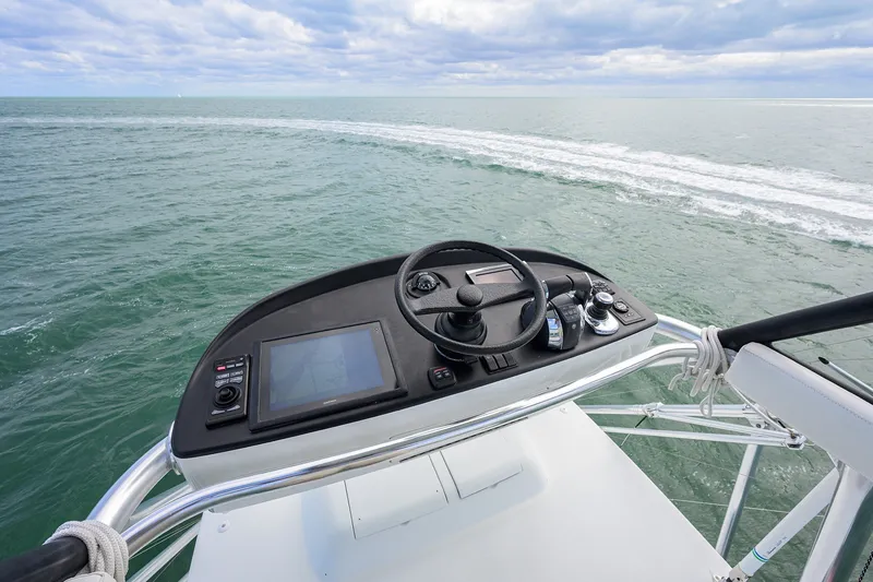 Slide: The Image of Helm of 2014 Release Boatworks 46 overlooking ocean waters. - 39