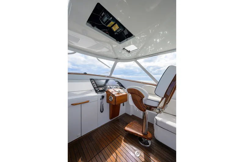 Slide: The Image of Helm of 2014 Release Boatworks 46 with wooden flooring and modern controls. - 34