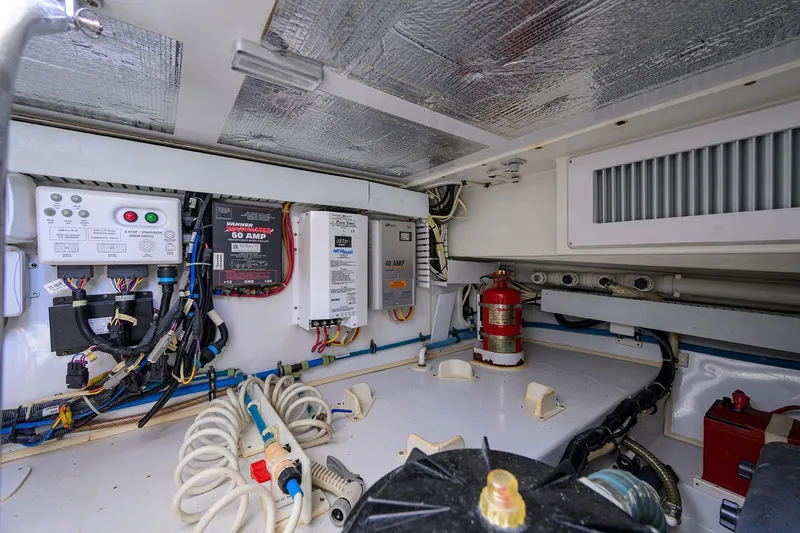 Slide: The Image of Electrical system and components inside a 2014 Release Boatworks 46, featuring wiring and safety equipment. - 62