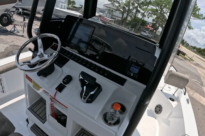 Slide: The Image of 2026 Seahunt BX25FS boat dashboard with steering wheel and controls. - 8