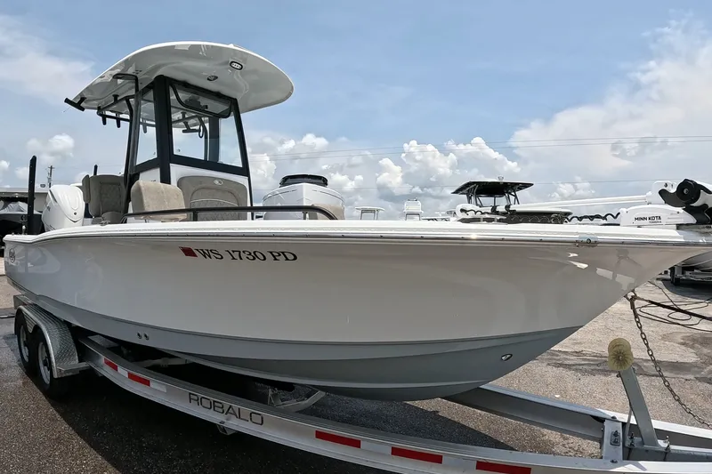 Slide: The Image of 2026 Seahunt BX25FS boat on trailer, displayed outdoors under a cloudy sky. - 5