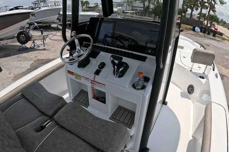 Slide: The Image of 2026 Seahunt BX25FS boat interior with steering wheel, controls, and seating. - 15