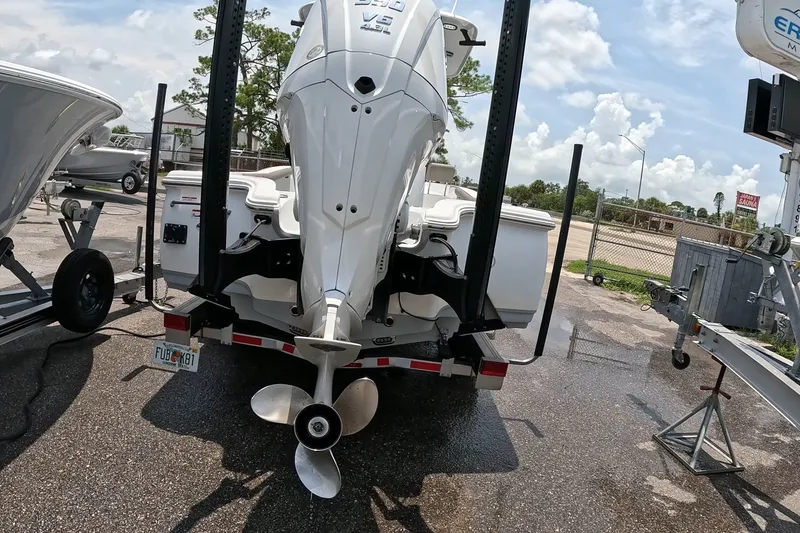 Slide: The Image of 2026 Seahunt BX25FS boat with powerful outboard motor on trailer, parked outdoors. - 24