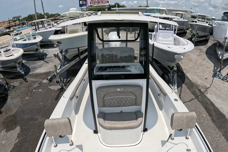Slide: The Image of 2026 Seahunt BX25FS boat displayed among other vessels at a dealership. - 11