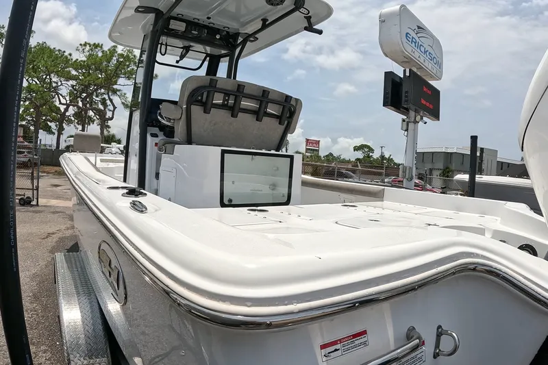 Slide: The Image of 2026 Seahunt BX25FS boat at marina, showcasing sleek design and modern features. - 21