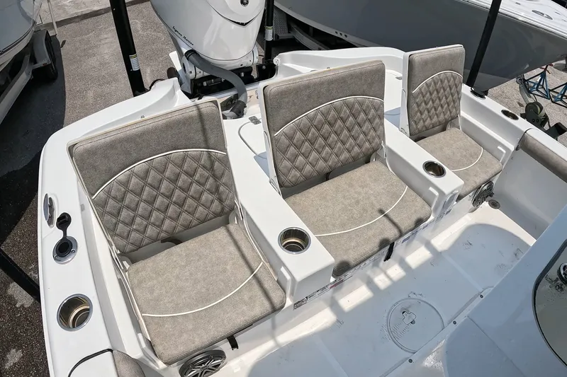 Slide: The Image of 2026 Seahunt BX25FS boat interior with three cushioned seats and cup holders. - 20