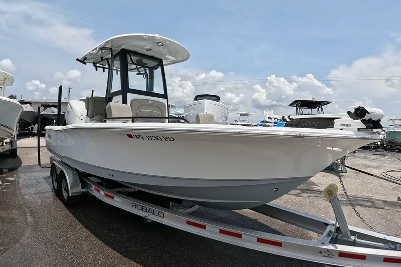 Slide: The Image of 2026 Seahunt BX25FS boat on trailer under clear sky at marina. - 6