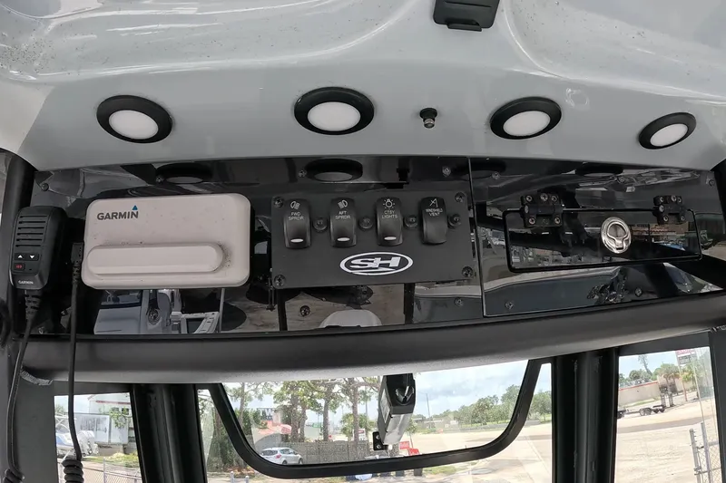 Slide: The Image of 2026 Seahunt BX25FS boat dashboard with Garmin device and control switches. - 23