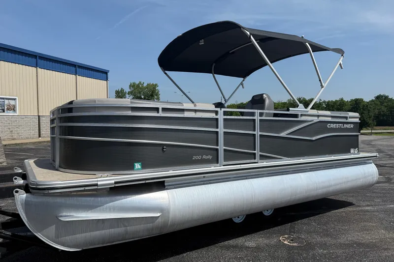 The Image of 2019 Crestliner 200 Rally DX CWDH pontoon boat with canopy, parked outdoors. - 1