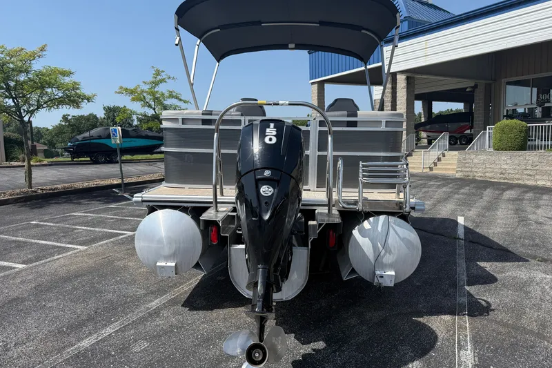 Slide: The Image of 2019 Crestliner 200 Rally DX CWDH pontoon boat with outboard motor in parking lot. - 26