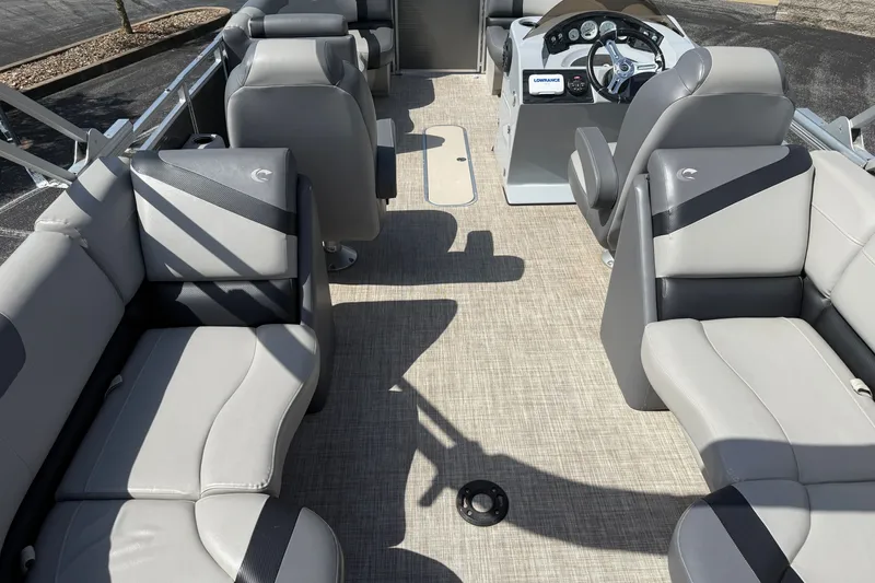 Slide: The Image of 2019 Crestliner 200 Rally DX CWDH pontoon boat interior with gray seating and steering console. - 5