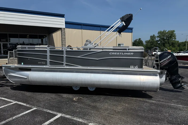 Slide: The Image of 2019 Crestliner 200 Rally DX CWDH pontoon boat with Mercury outboard motor, parked outdoors. - 3