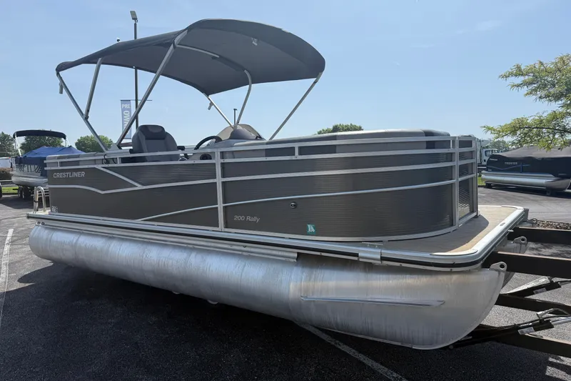 Slide: The Image of 2019 Crestliner 200 Rally DX CWDH pontoon boat with canopy, parked outdoors. - 25