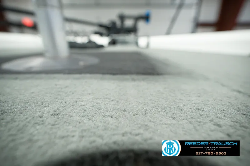 Slide: The Image of Carpeted deck of a 1998 Nitro 700 LX SC boat, with blurred background. - 46