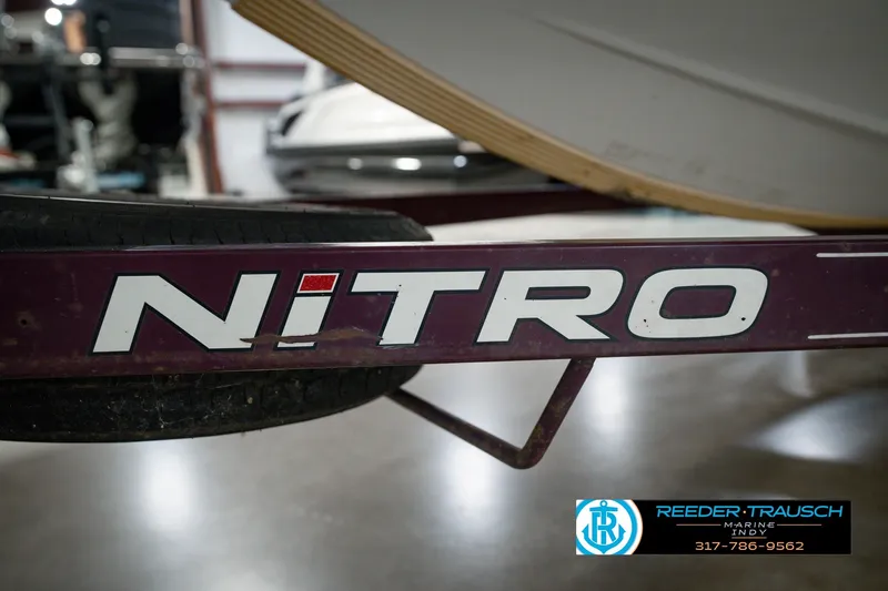 Slide: The Image of Close-up of a 1998 Nitro 700 LX SC boat trailer with logo. - 59
