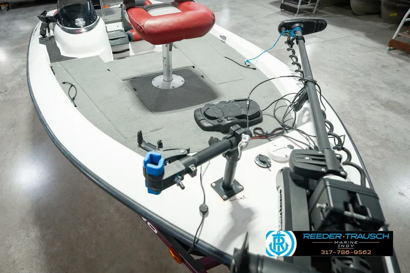 Slide: The Image of 1998 Nitro 700 LX SC fishing boat with red seat and trolling motor in showroom. - 13