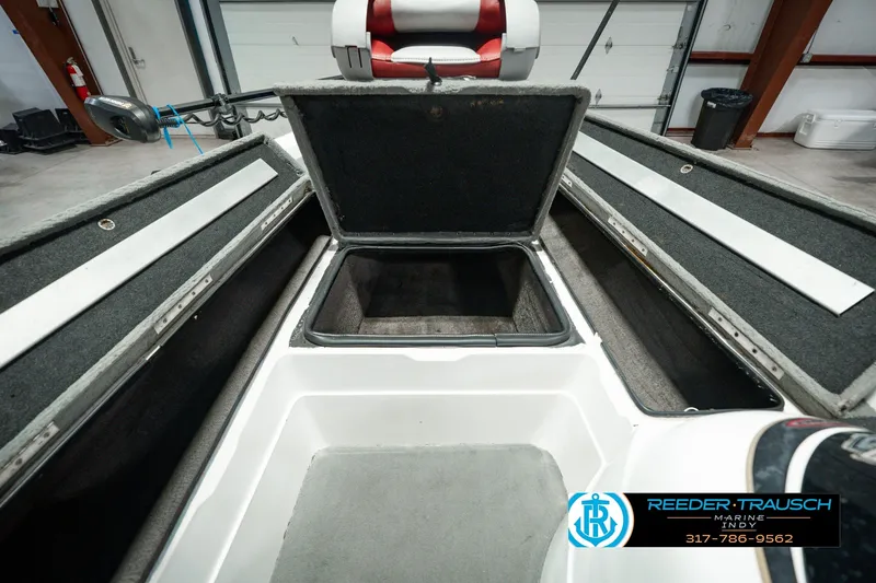 Slide: The Image of 1998 Nitro 700 LX SC boat interior with open storage compartments in a showroom. - 28