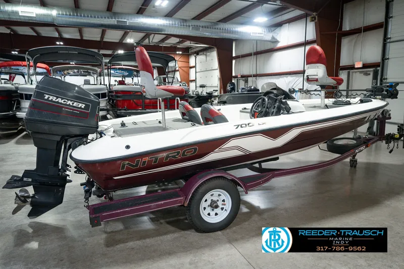 Slide: The Image of 1998 Nitro 700 LX SC boat with Tracker motor in indoor showroom. - 6