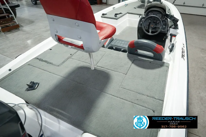 Slide: The Image of 1998 Nitro 700 LX SC boat interior with red seats and steering console. - 14