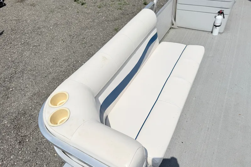 Slide: The Image of White seating on 2001 Harris Cruiser 220 boat with cup holders and fire extinguisher. - 4