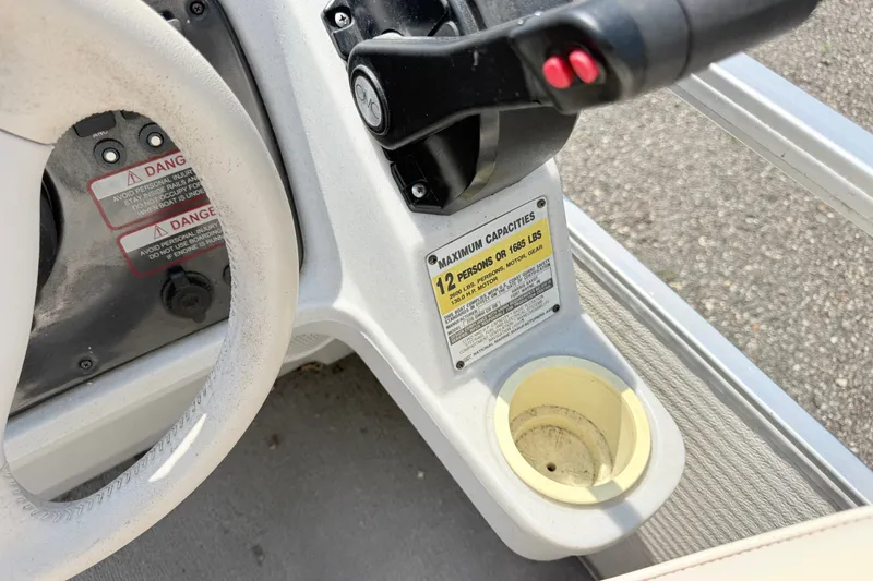 Slide: The Image of Steering wheel and controls of a 2001 Harris Cruiser 220 boat, showing capacity warning. - 10