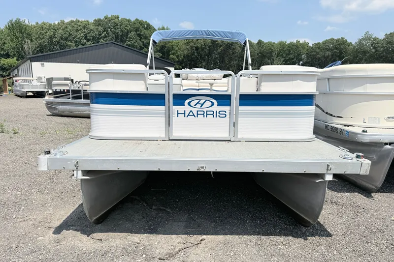 Slide: The Image of 2001 Harris Cruiser 220 pontoon boat parked on gravel lot. - 1