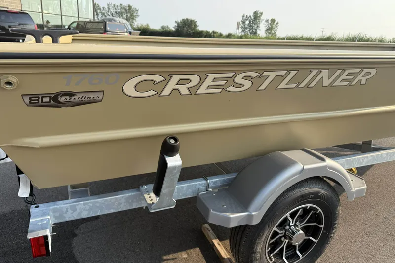 Slide: The Image of 2026 Crestliner 1760 Retriever Jon boat on trailer, showcasing logo and design details. - 12