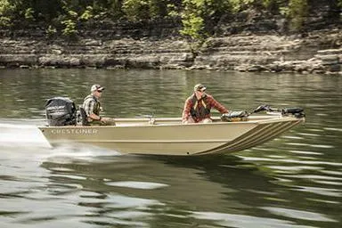 Slide: The Image of Manufacturer Provided Image: 2026 Crestliner 1760 Retriever Jon Deluxe boat cruising on a lake with two passengers. - 15