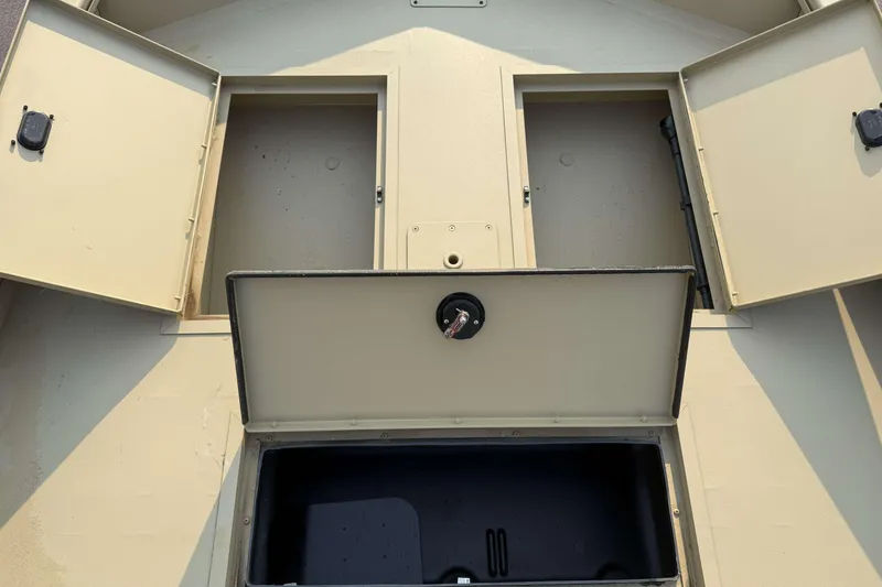 Slide: The Image of 2026 Crestliner 1760 Retriever Jon boat storage compartments open, showcasing interior space. - 8