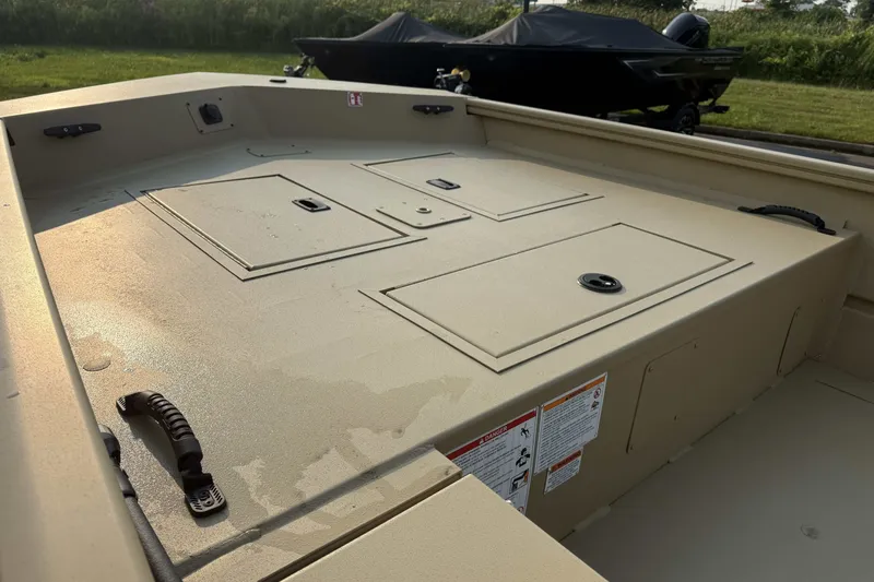 Slide: The Image of 2026 Crestliner 1760 Retriever Jon boat interior with storage compartments and handles. - 6