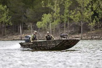 Slide: The Image of Manufacturer Provided Image: 2026 Crestliner 1760 Retriever Jon Deluxe boat on a lake with two passengers. - 14