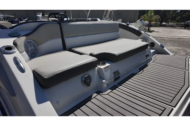 Slide: The Image of 2017 Starcraft Crossover 231 SCX OB boat seating area with gray cushions and deck. - 10