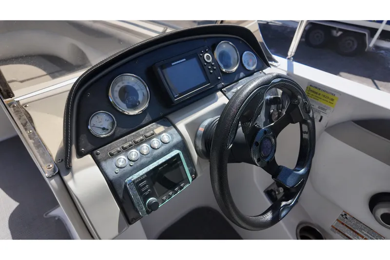Slide: The Image of 2017 Starcraft Crossover 231 SCX OB boat dashboard with steering wheel and gauges. - 14