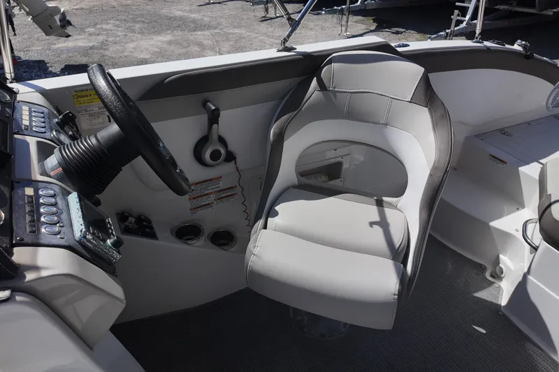 Slide: The Image of 2017 Starcraft Crossover 231 SCX OB boat cockpit with steering wheel and captain's chair. - 12