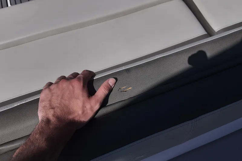 Slide: The Image of Hand touching upholstery on 2017 Starcraft Crossover 231 SCX OB boat seat. - 17