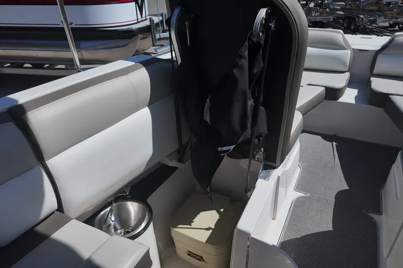 Slide: The Image of 2017 Starcraft Crossover 231 SCX OB boat interior with seating and storage compartments. - 15