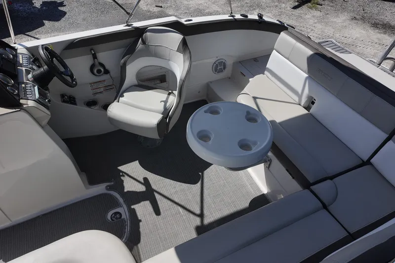 Slide: The Image of 2017 Starcraft Crossover 231 SCX OB boat interior with seating and steering console. - 8