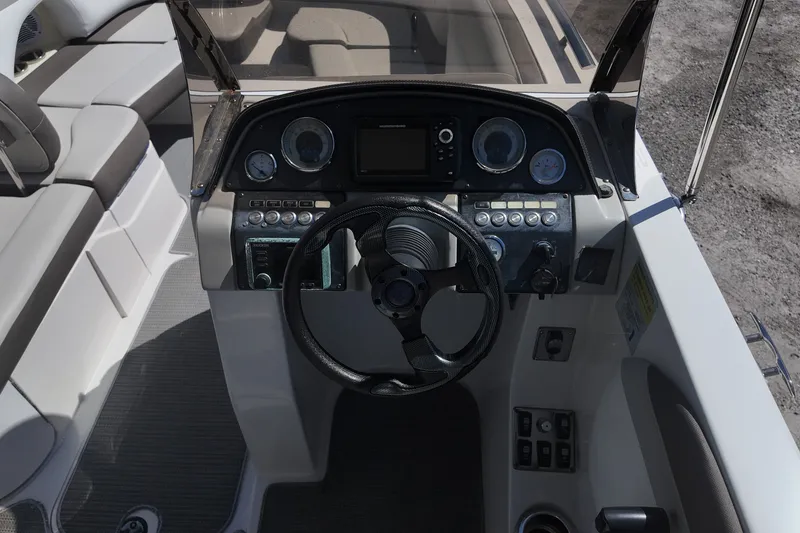 Slide: The Image of 2017 Starcraft Crossover 231 SCX OB boat dashboard with steering wheel and controls. - 13