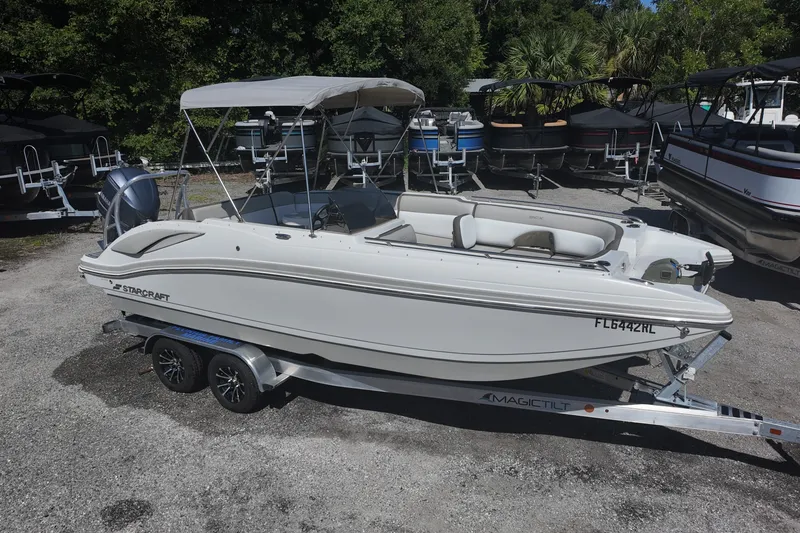 The Image of 2017 Starcraft Crossover 231 SCX OB boat on trailer, parked outdoors. - 0