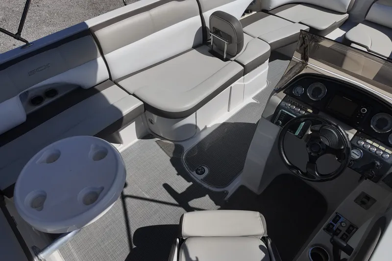 Slide: The Image of 2017 Starcraft Crossover 231 SCX OB boat interior with seating and control panel. - 5