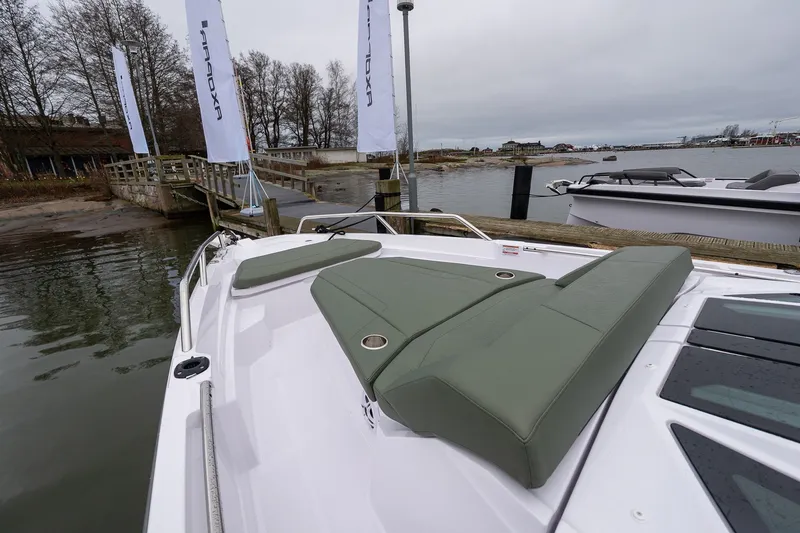 Slide: The Image of 2027 Axopar 38 Cross Cabin boat docked, featuring sleek design and comfortable seating. - 22